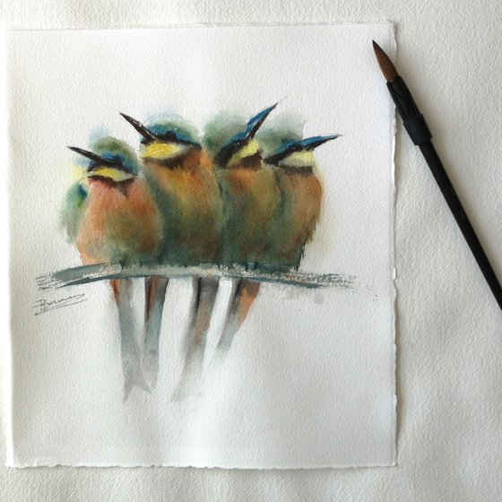 Four bee-eater birds on a branch