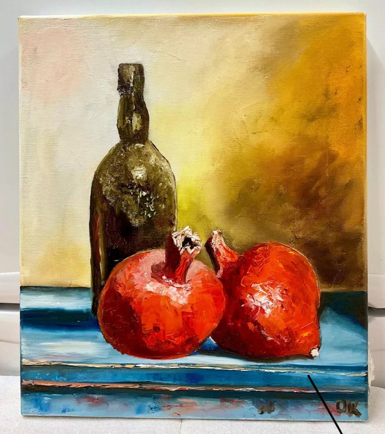 Pomegranates and oil bottle