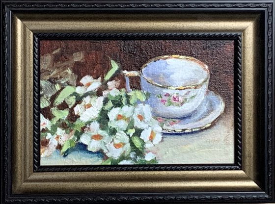 Tea cup with white flowers.