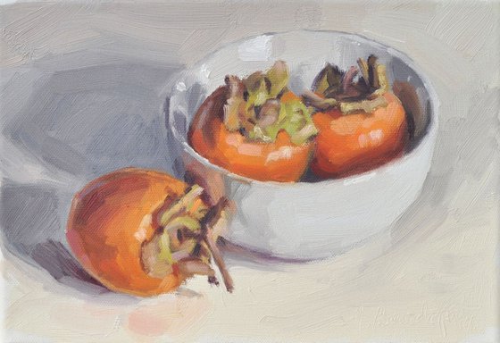 Persimmons in a white Bowl