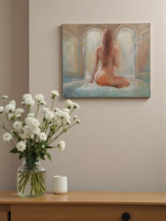 Nude woman seated by the pool