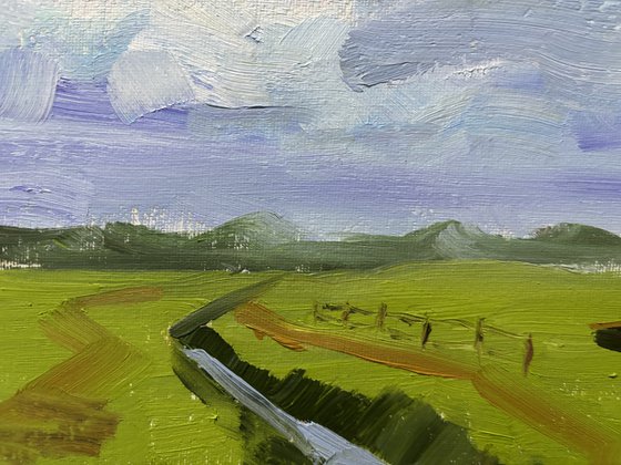 Clouds over the field and ditch