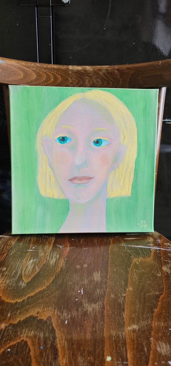 Young and blond soft green woman portrait