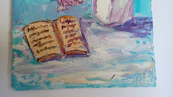 Lilac flowers and a book still life