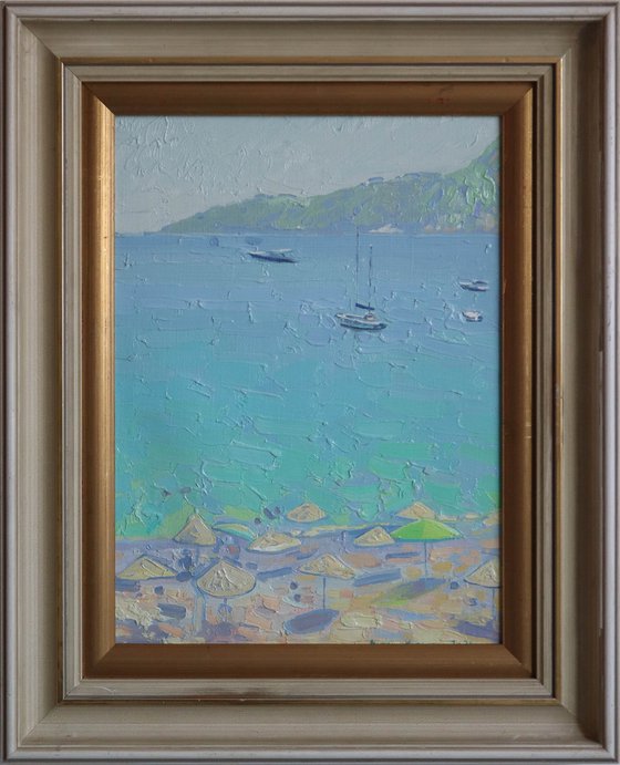 Yachts and umbrellas on the beach