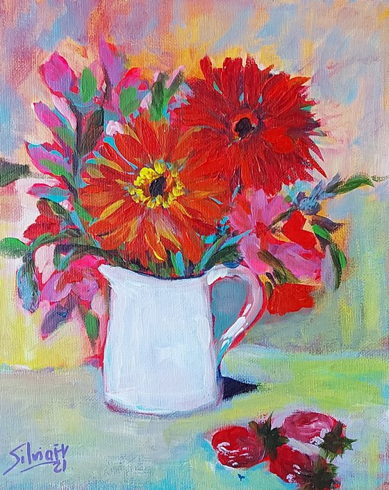 Flowers in a jug with strawberries.