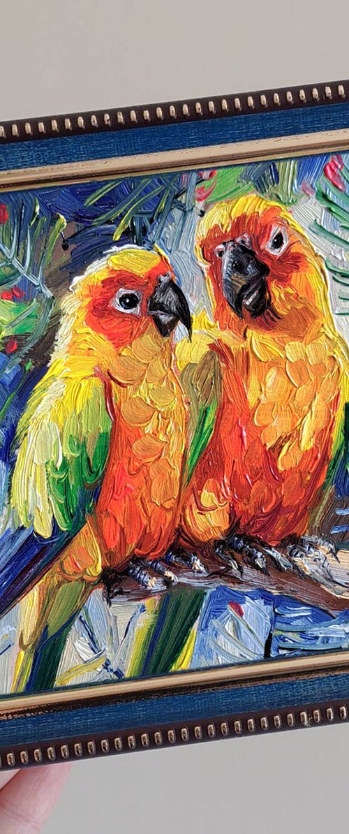 Two red yellow parrot birds by Nataly Derevyanko