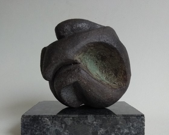 Crouching figure, protection in stone.