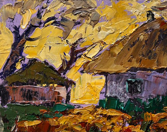 Yellow sunset behind houses