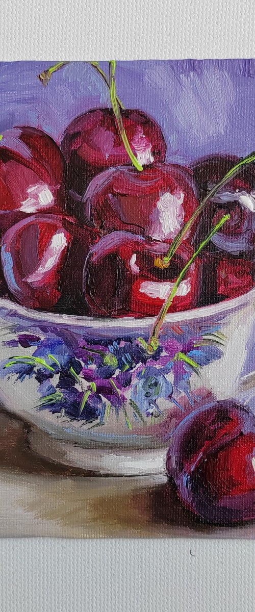 Cherries in porcelain cup by Leyla Demir