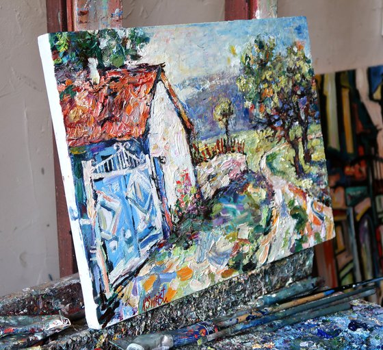 Blue gate, road and trees.