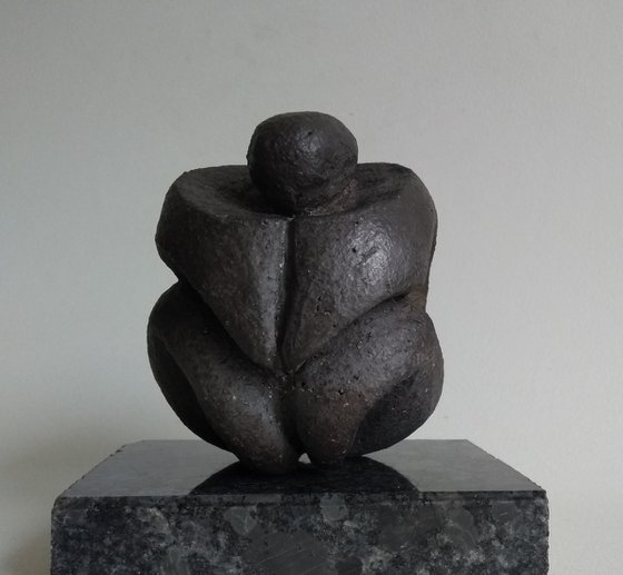 Crouching figure, protection in stone.