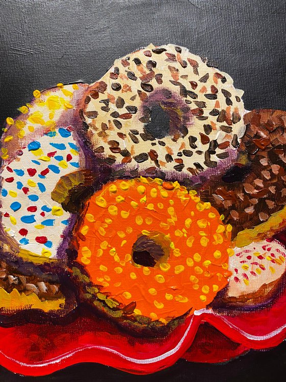Colourful donuts in red dish