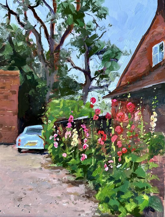Hollyhocks and blue car