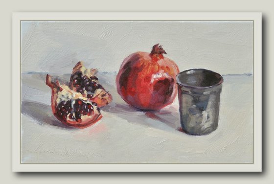 Pomegranates and tin cup