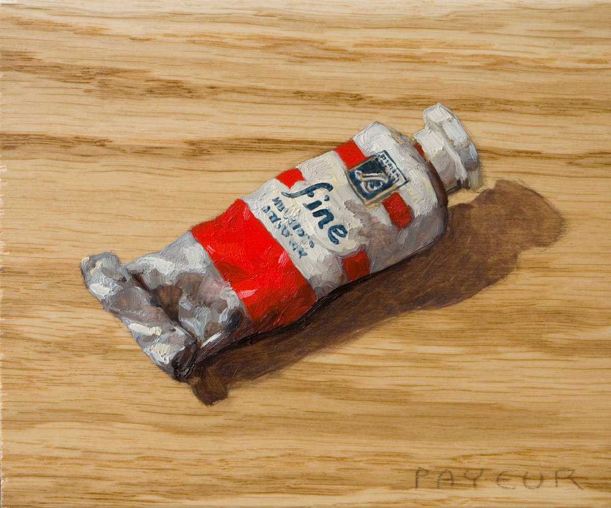 modern still life of a red color painting tube on a plank board by Olivier Payeur