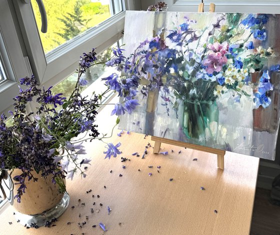 Blue wildflowers on window