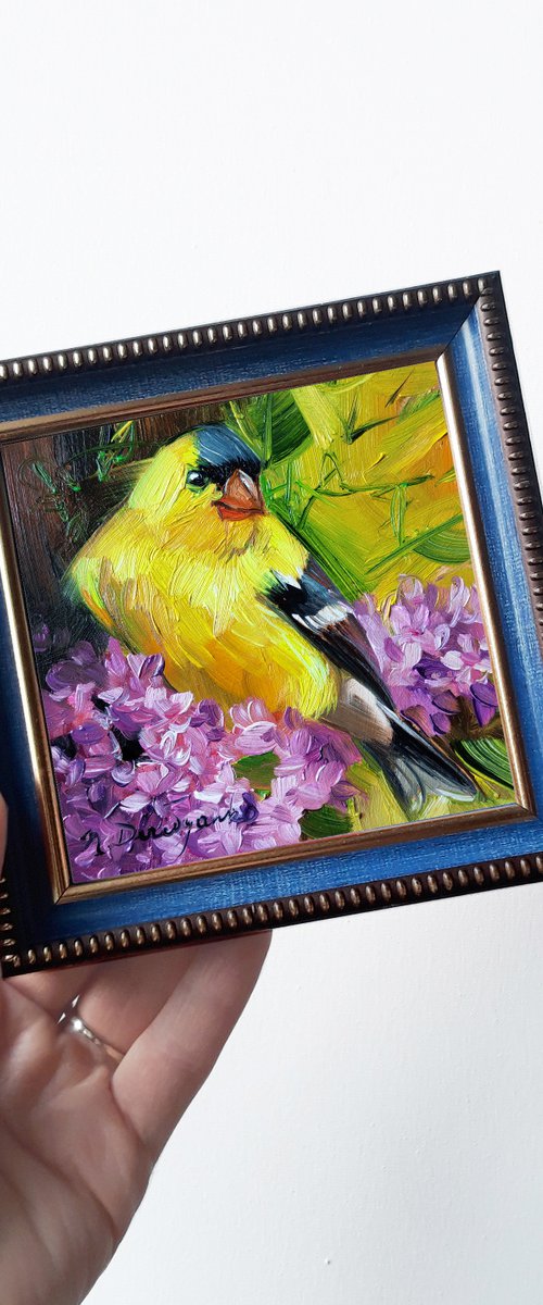 Yellow bird on blossom branch by Nataly Derevyanko