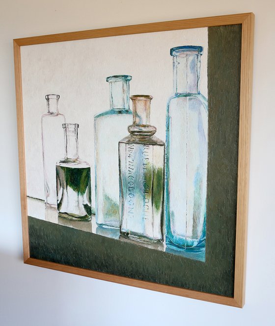 Five vintage bottles on window sill