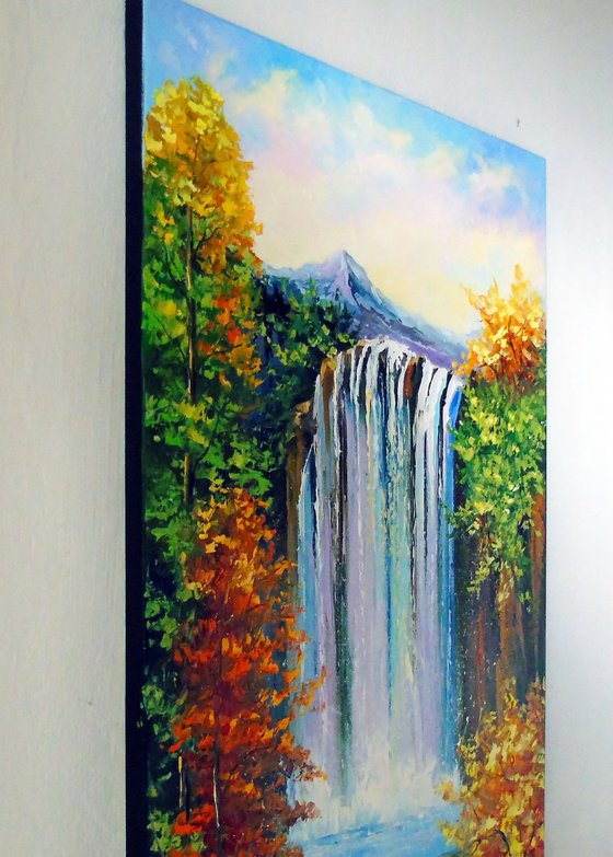 Mountain waterfall by the lake