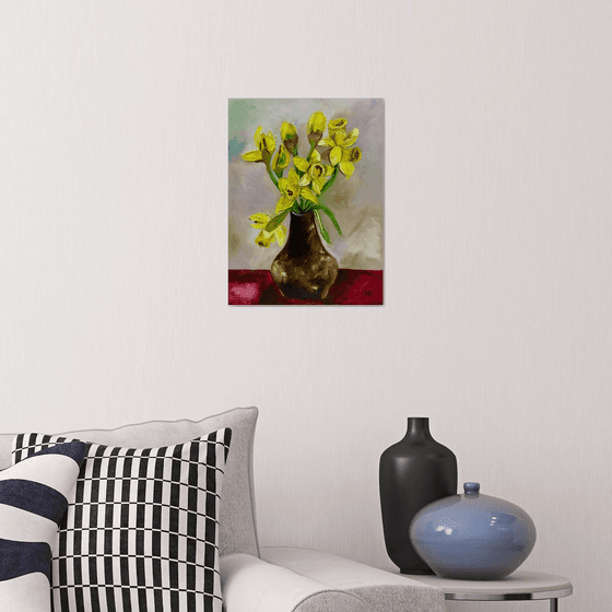 Bouquet of Daffodils on red table, still life inspired by spring.