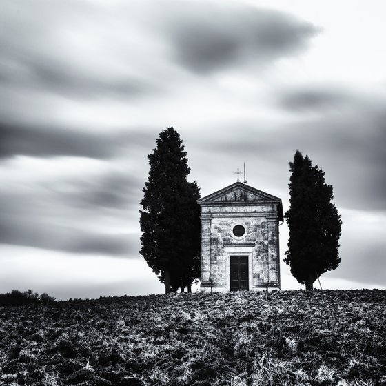 A small chapel with cypresses