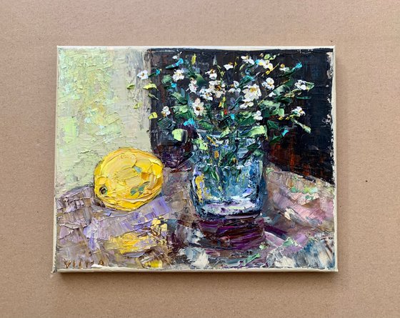 Still life with wildflowers and a lemon