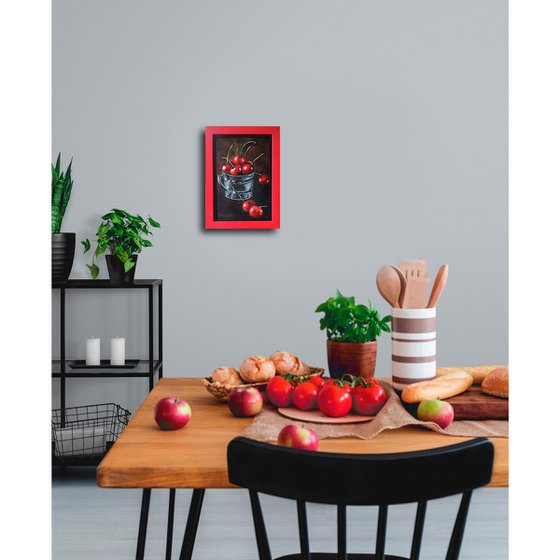 Red cherries in a metal cup