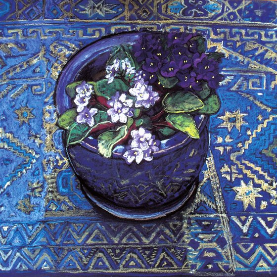 African violet flowers still life on blue patterned cloth