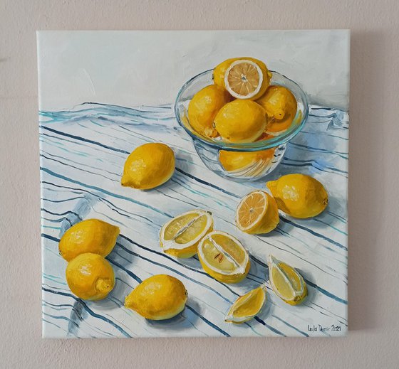 Lemons in glass bowl on stripen tablecloth