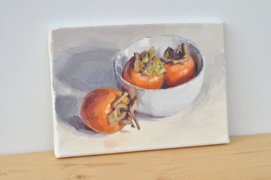 Persimmons in a white Bowl