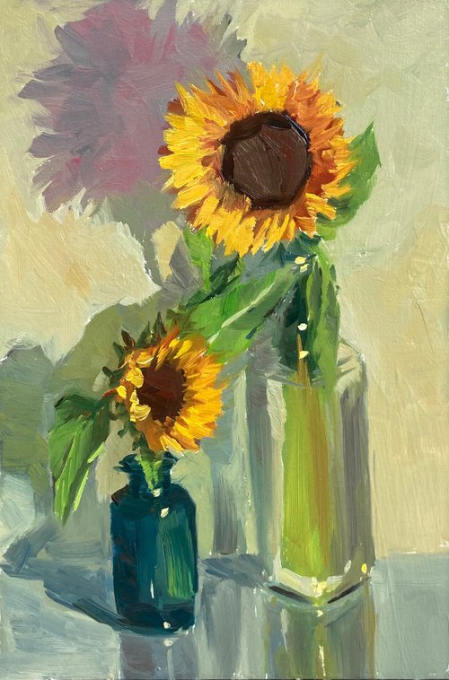 Sunflowers with a blue glass by Nithya Swaminathan
