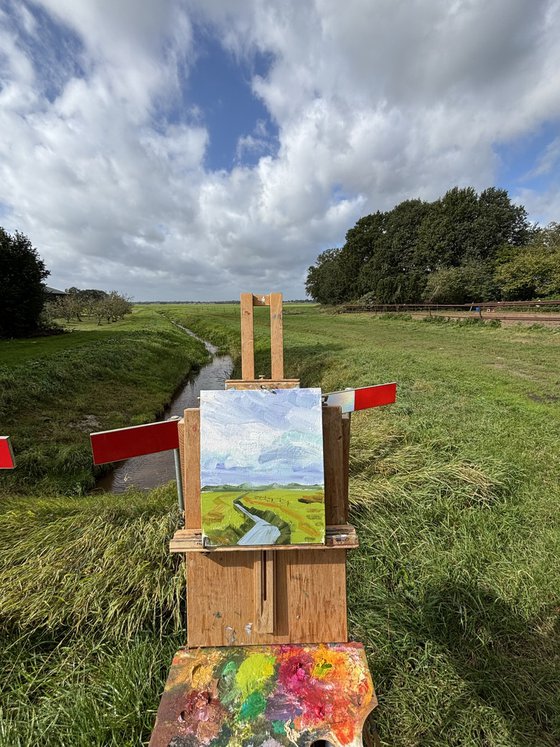 Clouds over the field and ditch