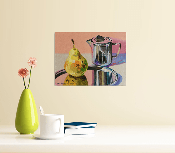 Metallic coffee pot and pear on a silver tray