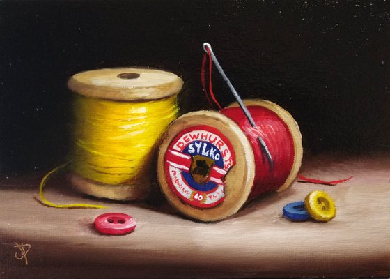Vintage cotton reels with buttons still life