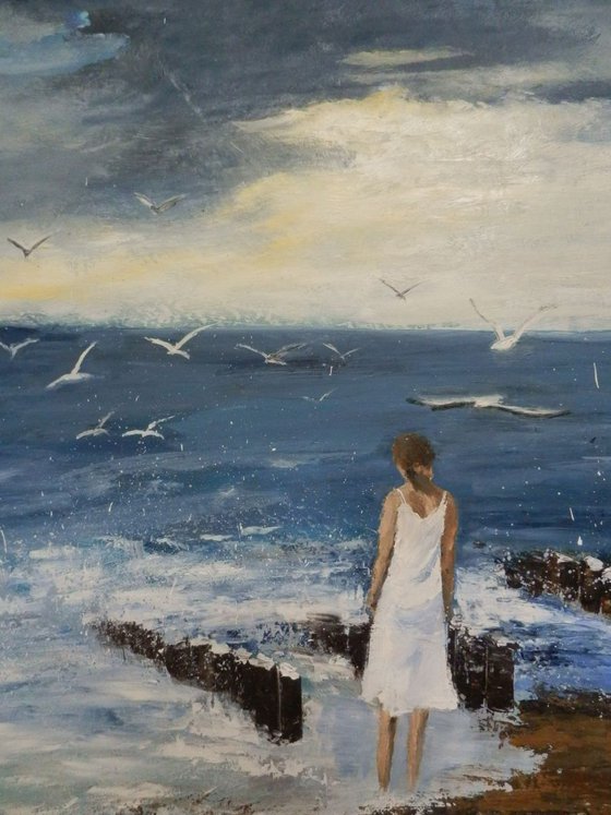 Seagulls and a lonely woman at seashore