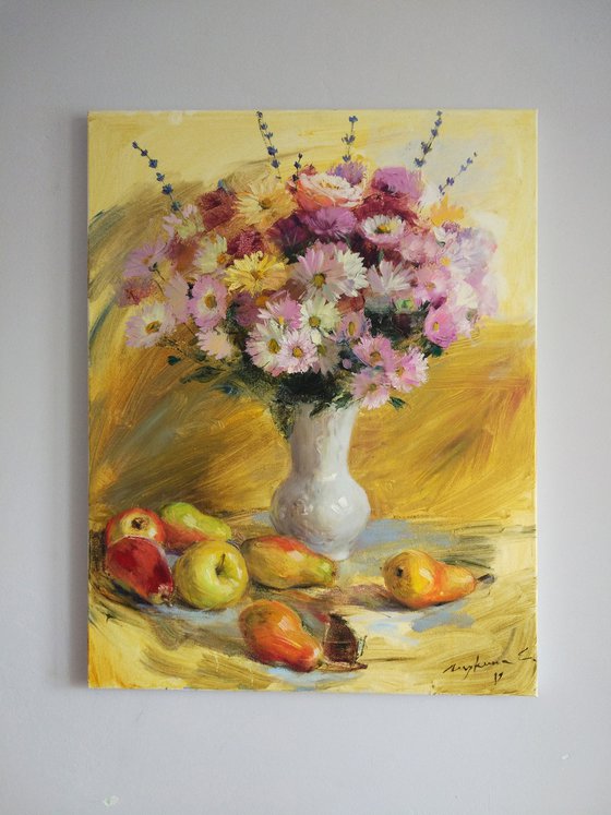Autumn gifts. Flowers and fruits