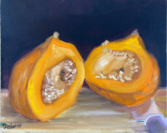 A small pumpkin cut in a half. still life