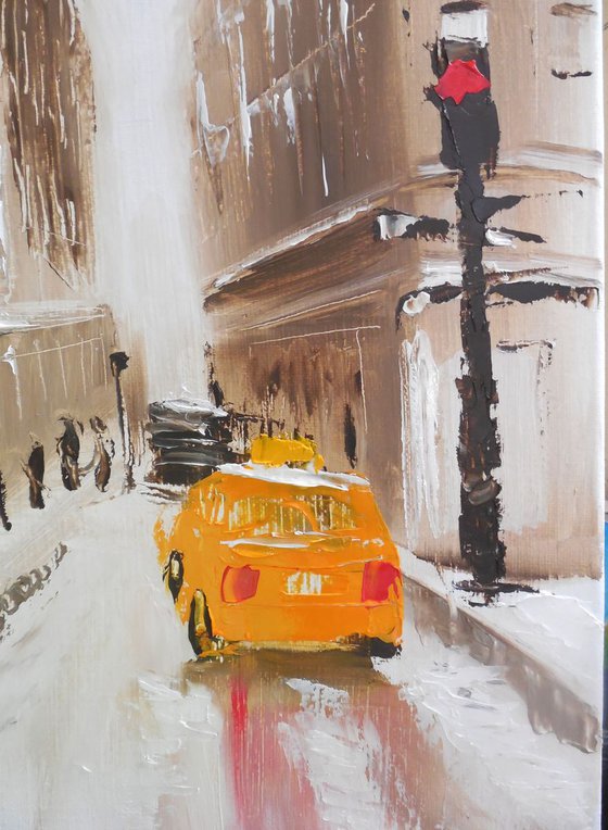 Winter city street with yellow taxi
