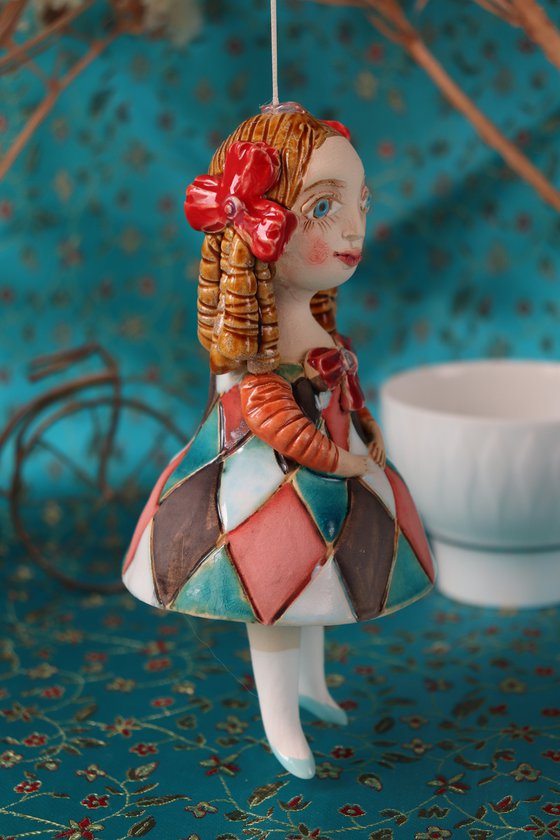 Little Girl in Harlequin dress. Tiny hanging sculpture