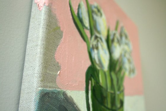 Tulips in a green glass