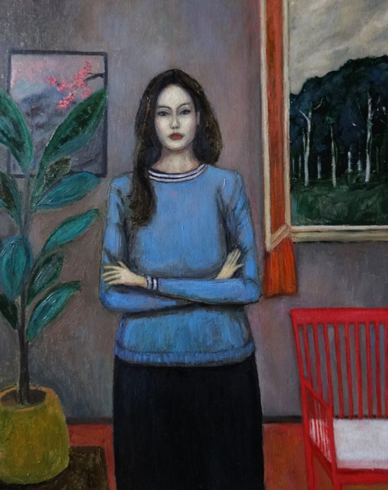 Woman with plant and red chair