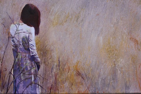 Woman standing on the edge of a cornfield.