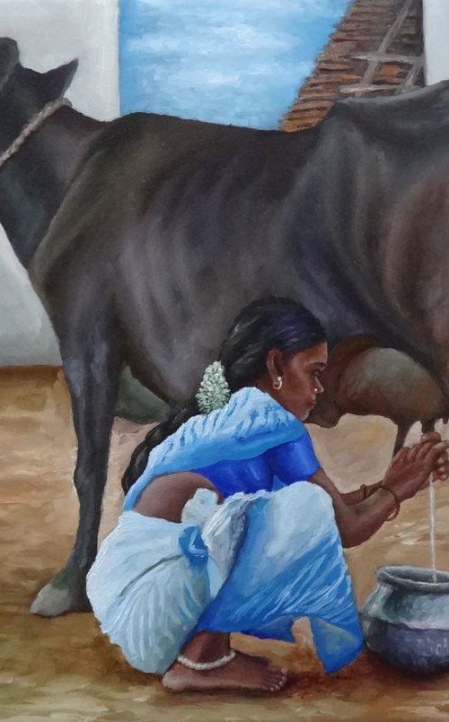 Woman milking cow by Ramya Sadasivam