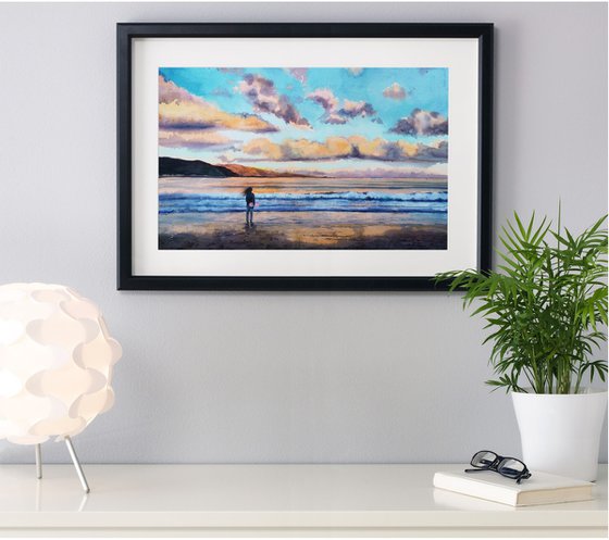 Young girl with skateboard seafront