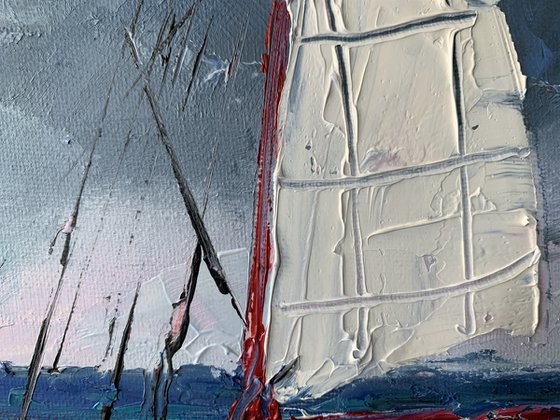 Red sail boat.
