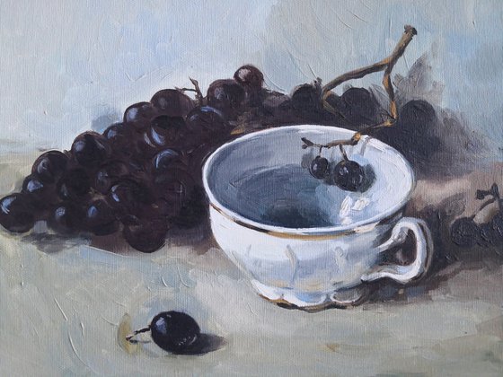 Black grapes and a porcelain cup still life