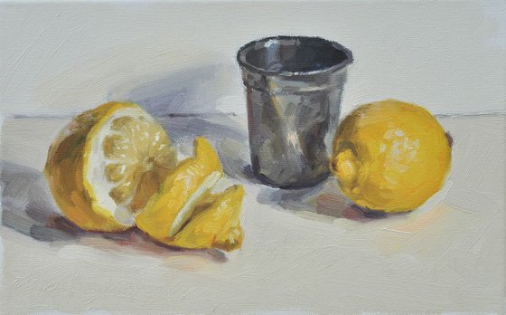 Lemons and tin cup