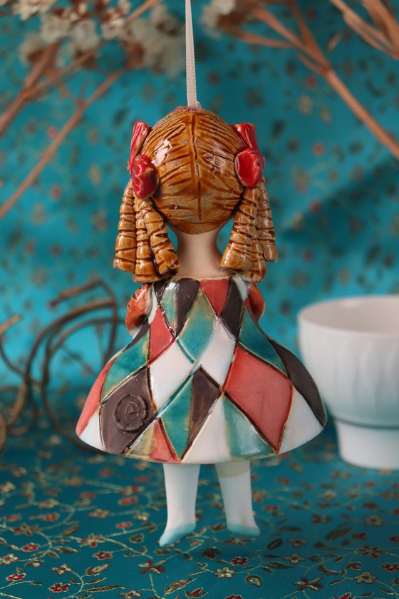 Little Girl in Harlequin dress. Tiny hanging sculpture