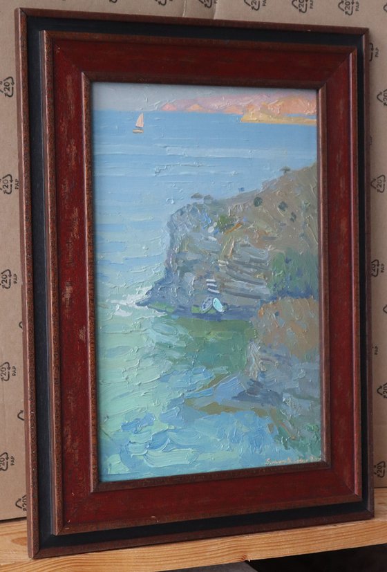 A lonely white sail gleams